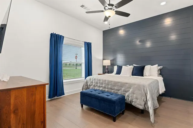 a bedroom with a large bed and a chandelier