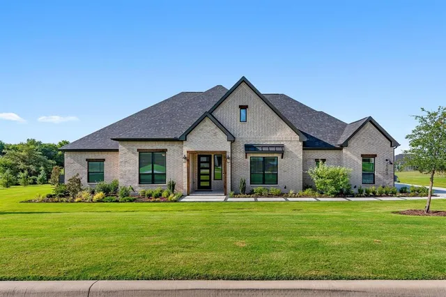 a front view of house with yard and green space