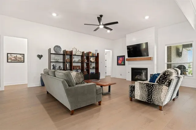 a living room with furniture a fireplace and a flat screen tv