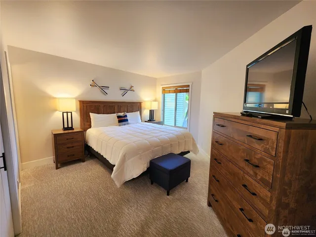 a bedroom with a bed and a flat screen television