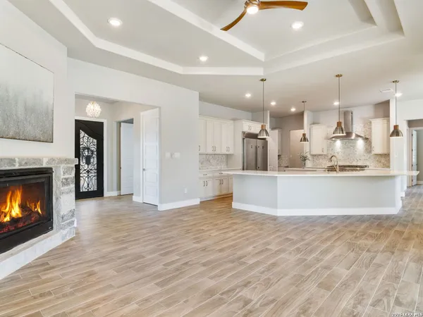 a view of empty room with wooden floor and fireplace