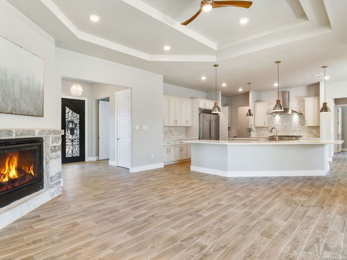 250 Private Road 2775 Mico, TX 78056 - Photo 11 of 57 a view of a kitchen with a stove wooden cabinets and a fireplace
