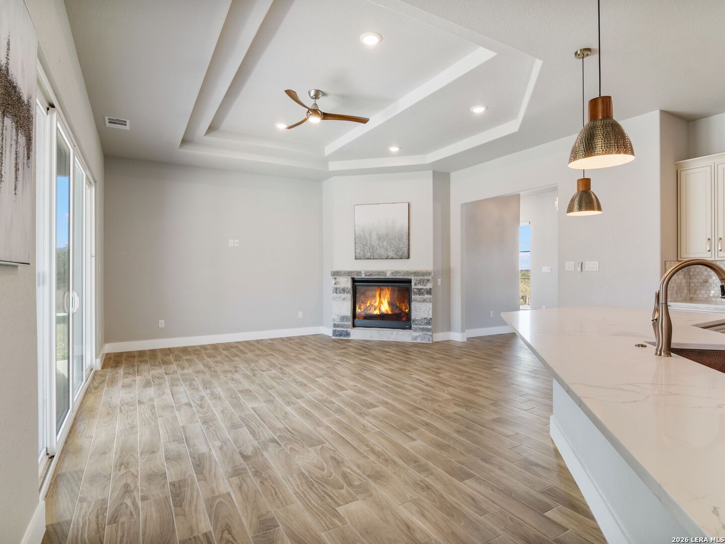 250 Private Road 2775 Mico, TX 78056 - Photo 13 of 57 a view of empty room with wooden floor and fireplace