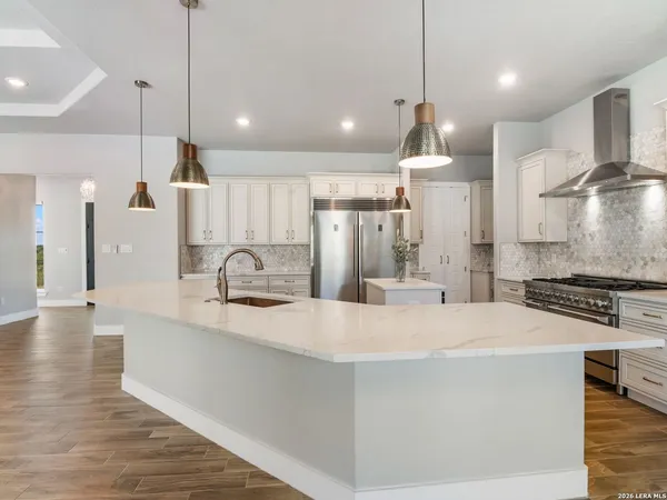 a kitchen with a sink stove and cabinets