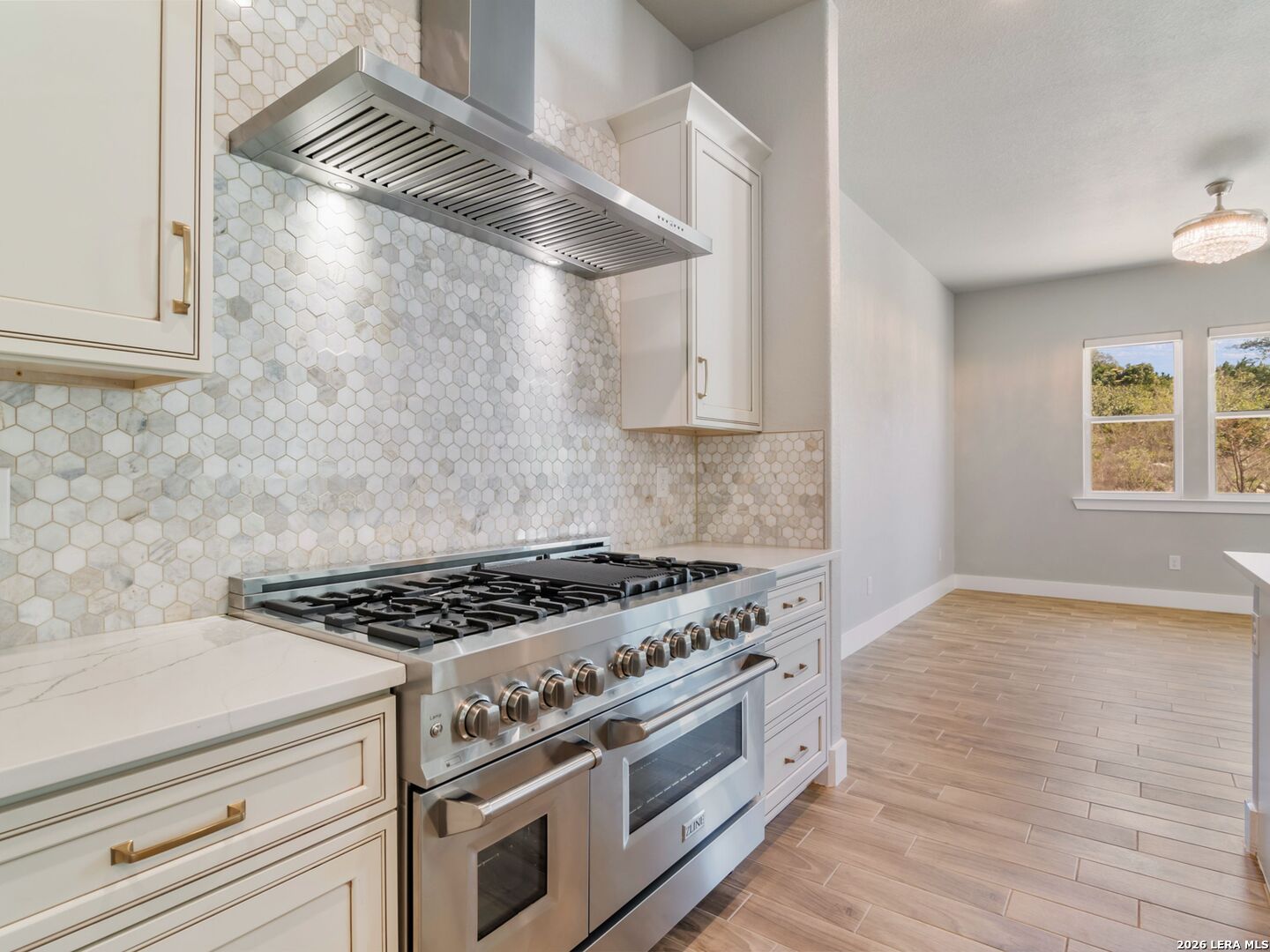 250 Private Road 2775 Mico, TX 78056 - Photo 20 of 57 a kitchen with granite countertop a stove and a white cabinets