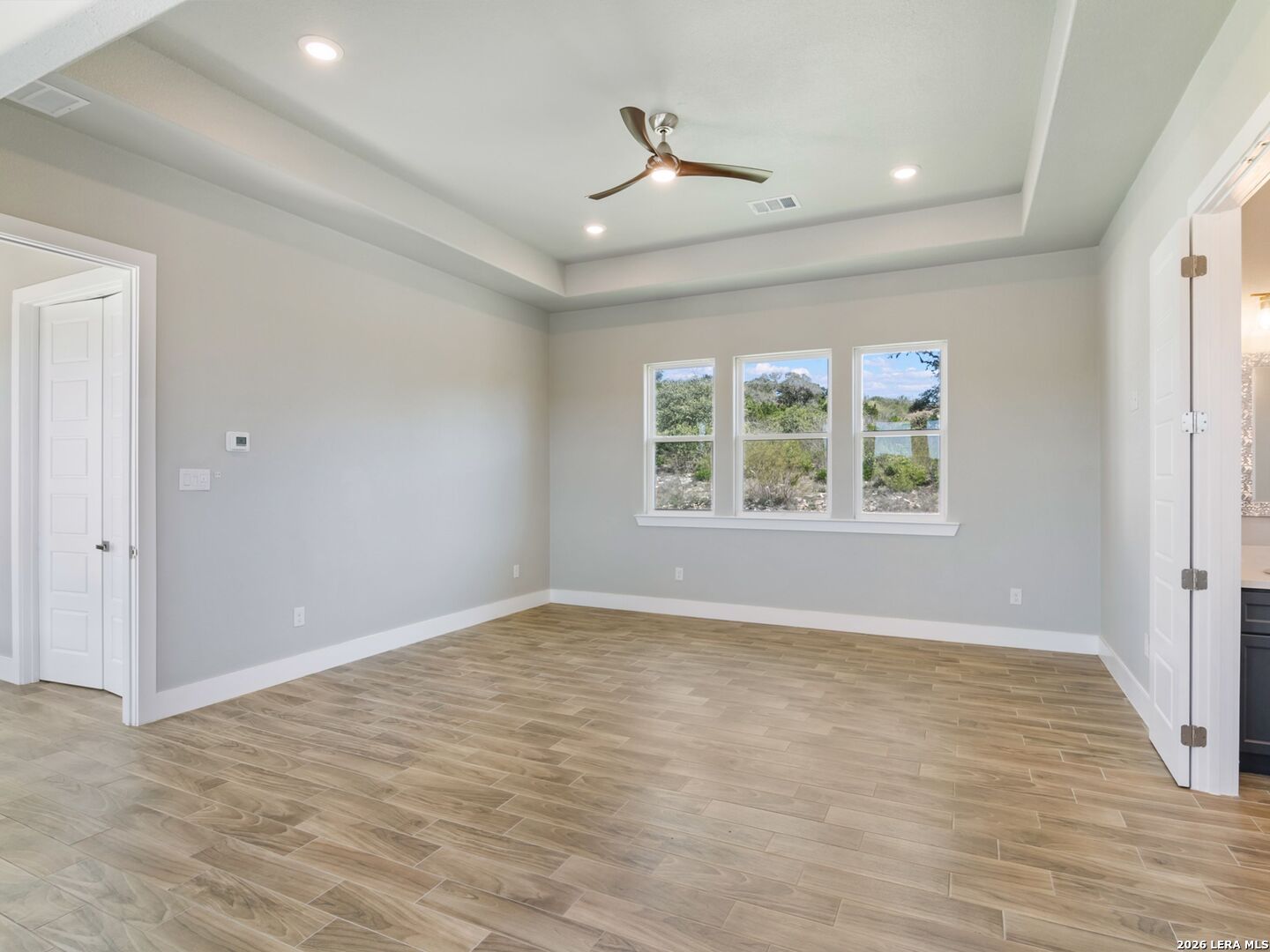 250 Private Road 2775 Mico, TX 78056 - Photo 28 of 57 a view of an empty room with wooden floor and a window