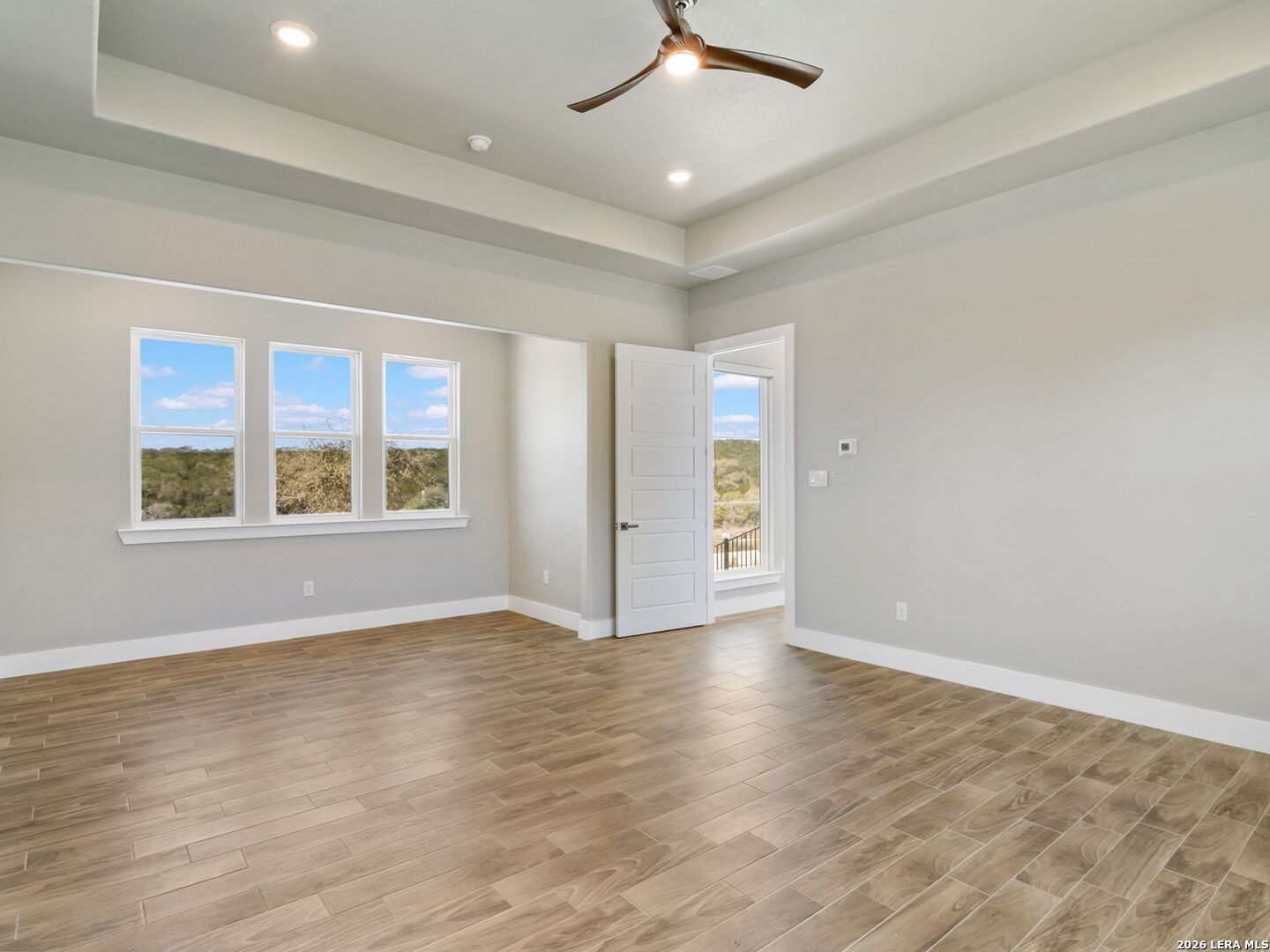 250 Private Road 2775 Mico, TX 78056 - Photo 30 of 57 an empty room with wooden floor chandelier and windows