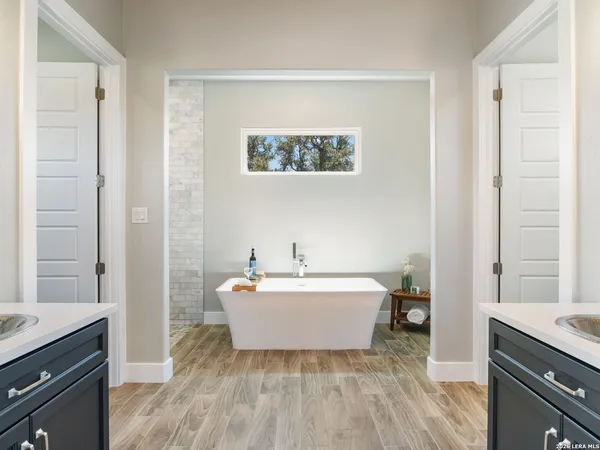 a bathroom with a double vanity sink and a mirror