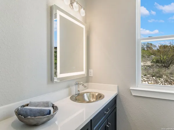 a bathroom with a sink a tub and a mirror