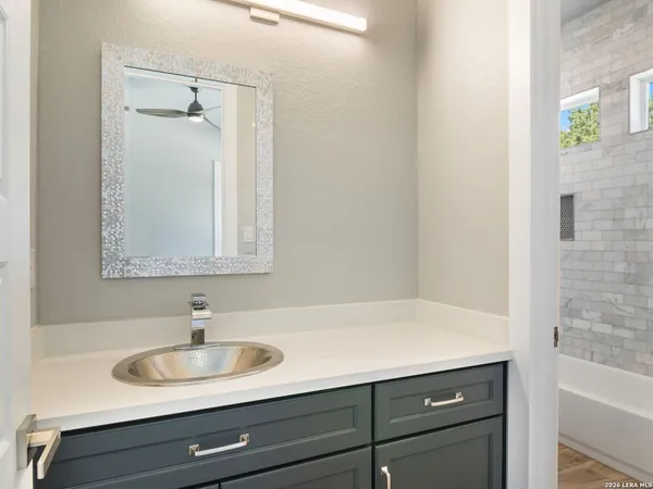a bathroom with a sink and a mirror