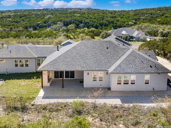 an aerial view of a house with a yard
