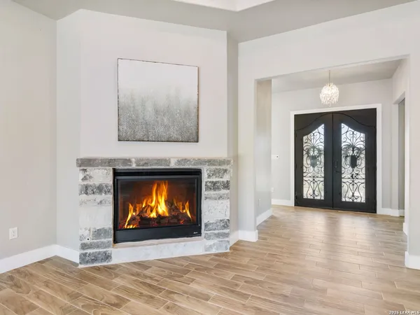 a view of a kitchen with a stove wooden cabinets and a fireplace