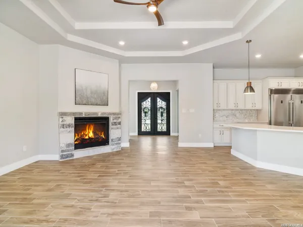 a view of an empty room with a fireplace and a window