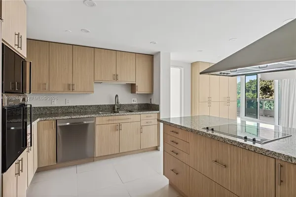 a kitchen with granite countertop white cabinets and white appliances