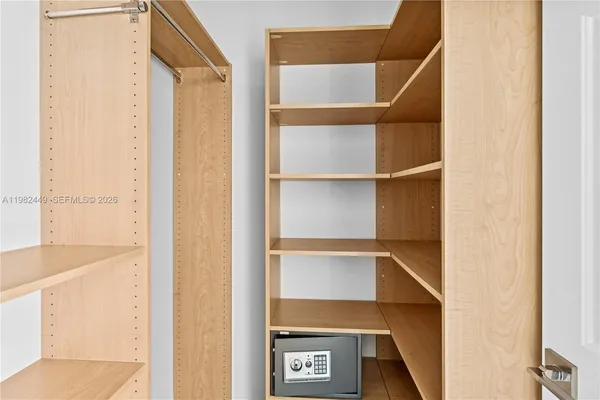 a view of an empty walk in closet with empty racks