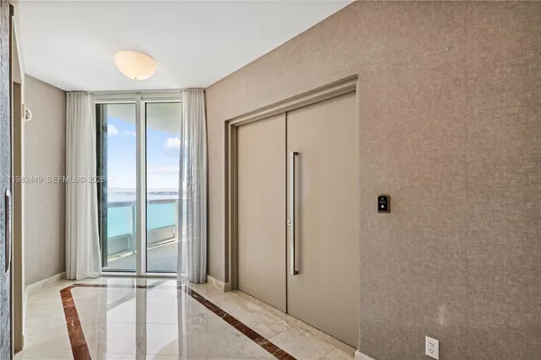 a view of a bathroom with a shower and a window