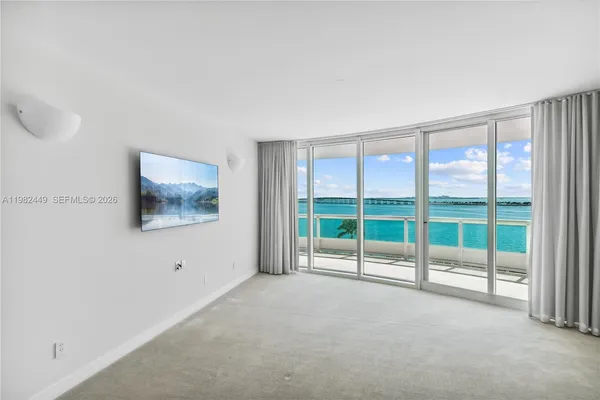 a view of an empty room with glass windows