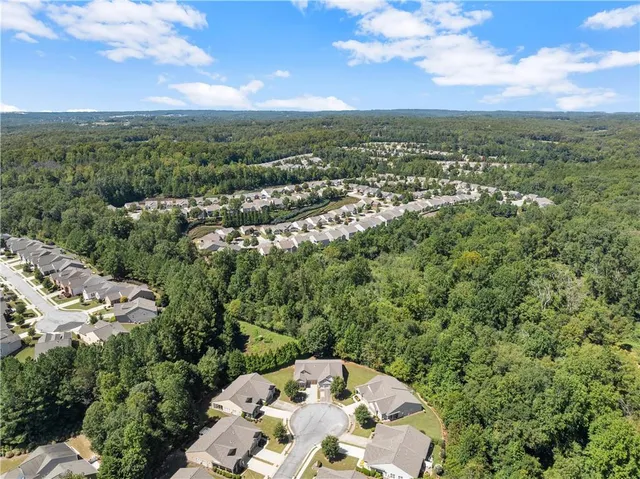 an aerial view of a residential houses with outdoor space