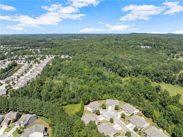 an aerial view of a residential houses with city view