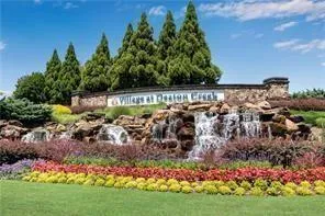 a front view of a house with a yard and potted plants