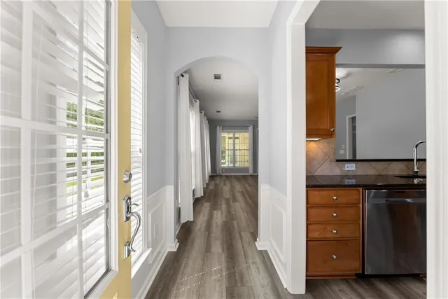 a view of a hallway with wooden floor and staircase