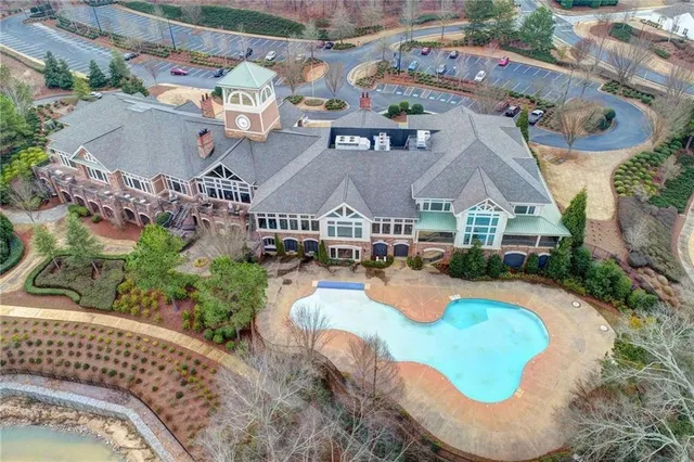 an aerial view of a house with a garden and trees