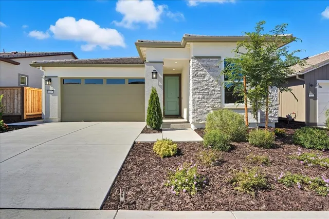 a front view of a house with garden