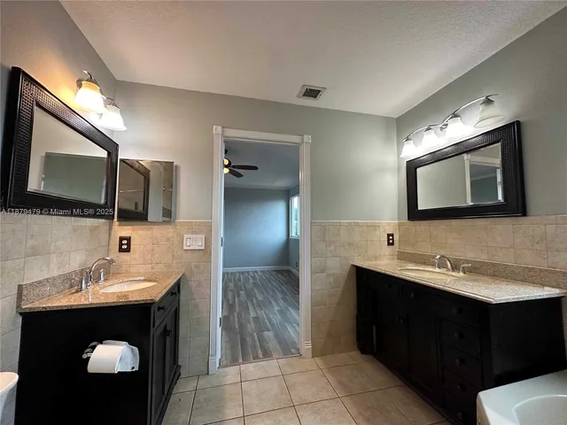 a bathroom with a sink toilet bathtub and mirror