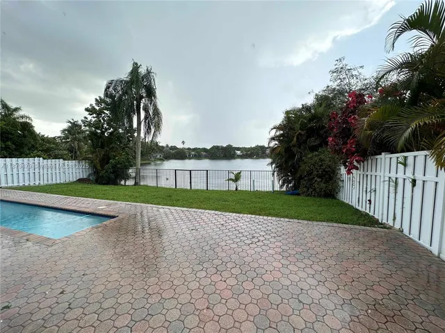 a view of swimming pool with a yard