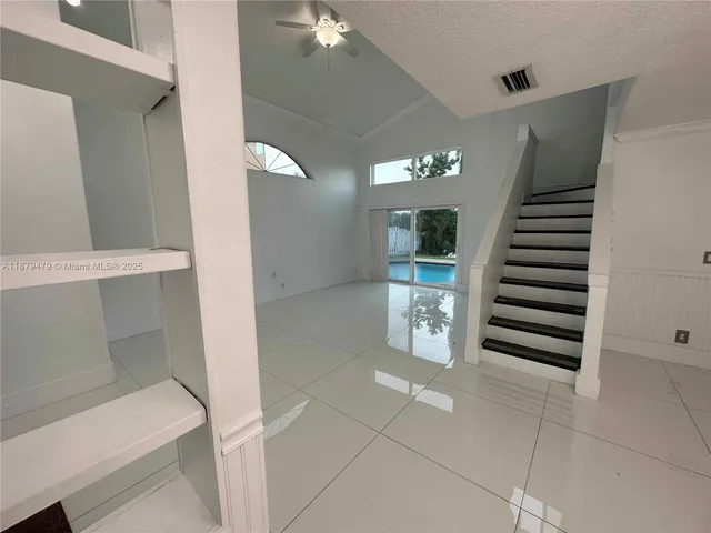 a view of a kitchen with a sink and refrigerator wooden floor