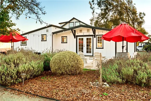 a view of a house with a yard and sitting area