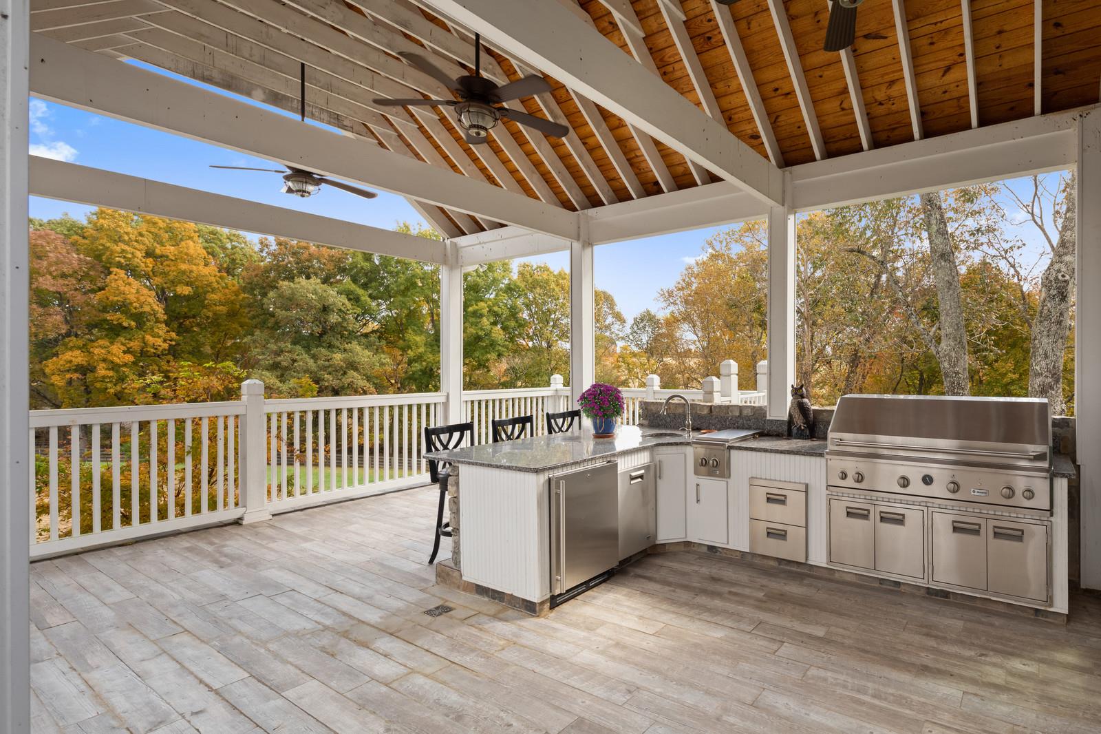 4304 Clarence Murphy Road Springfield, TN 37172 - Photo 21 of 30 a open kitchen with stainless steel appliances a stove a sink and white cabinets with wooden floor