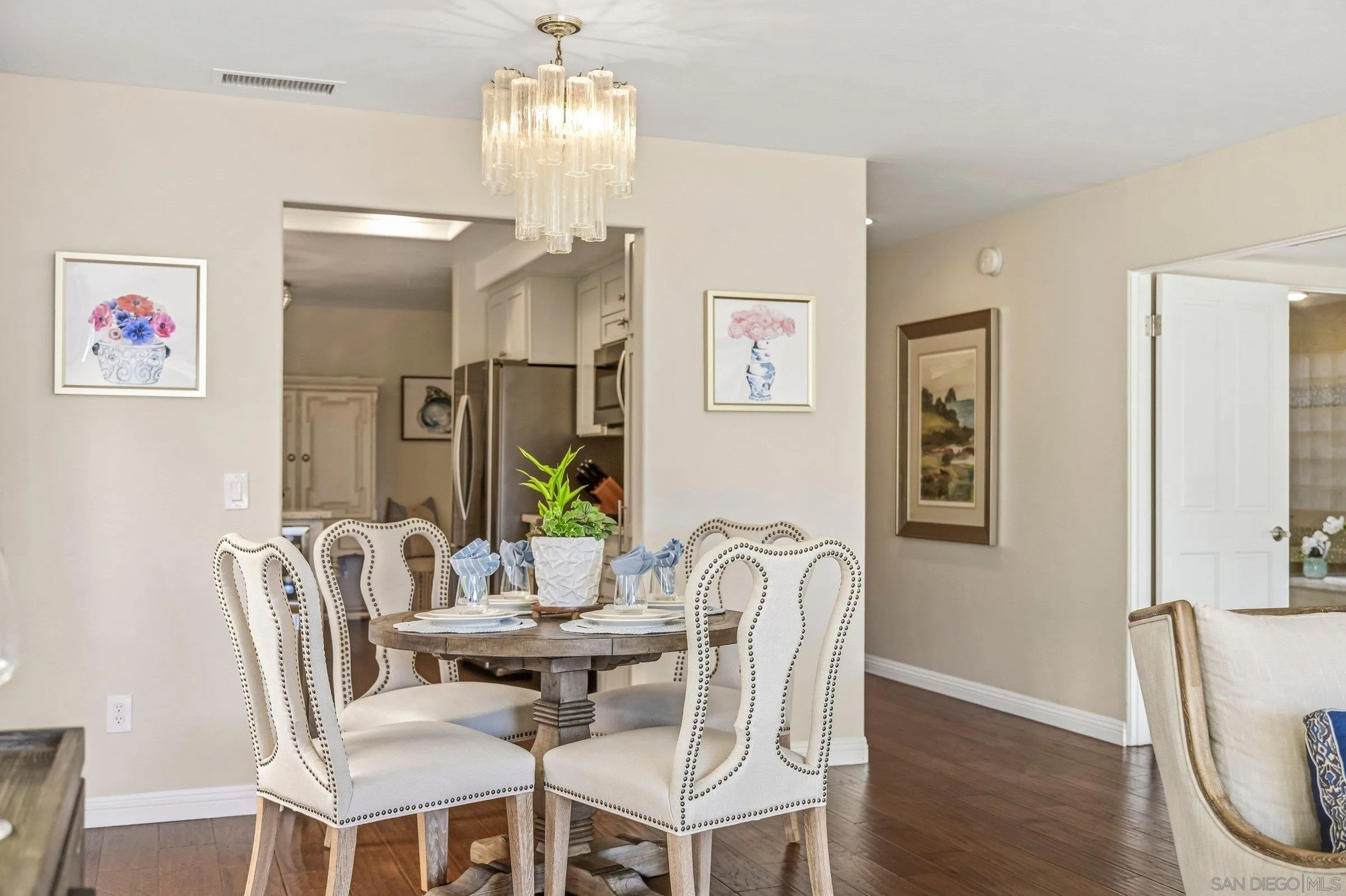 52 Spinnaker Way Coronado, CA 92118 - Photo 11 of 45 a dining room with furniture a chandelier and wooden floor
