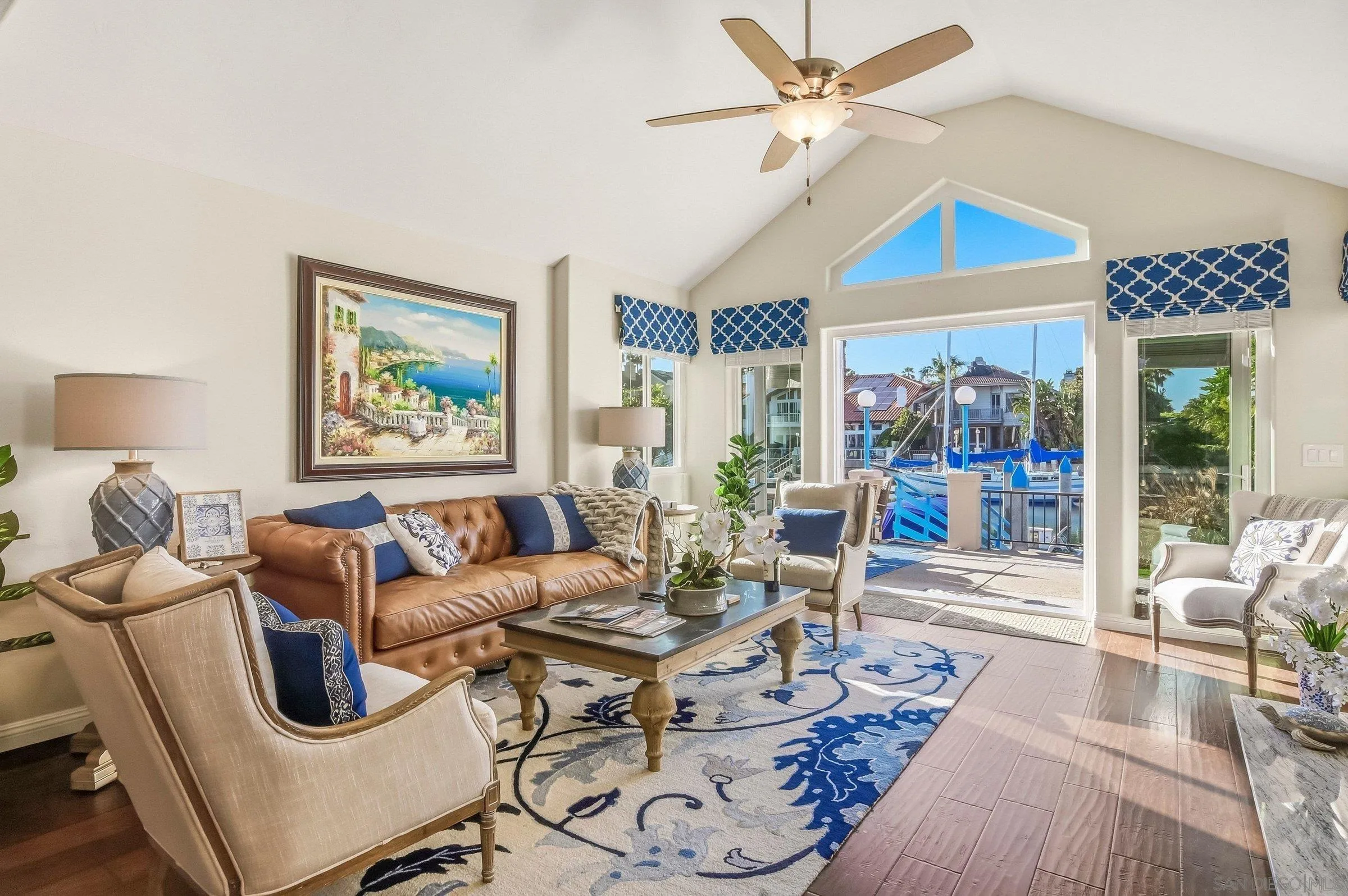52 Spinnaker Way Coronado, CA 92118 - Photo 15 of 45 a living room with furniture a flat screen tv and a floor to ceiling window