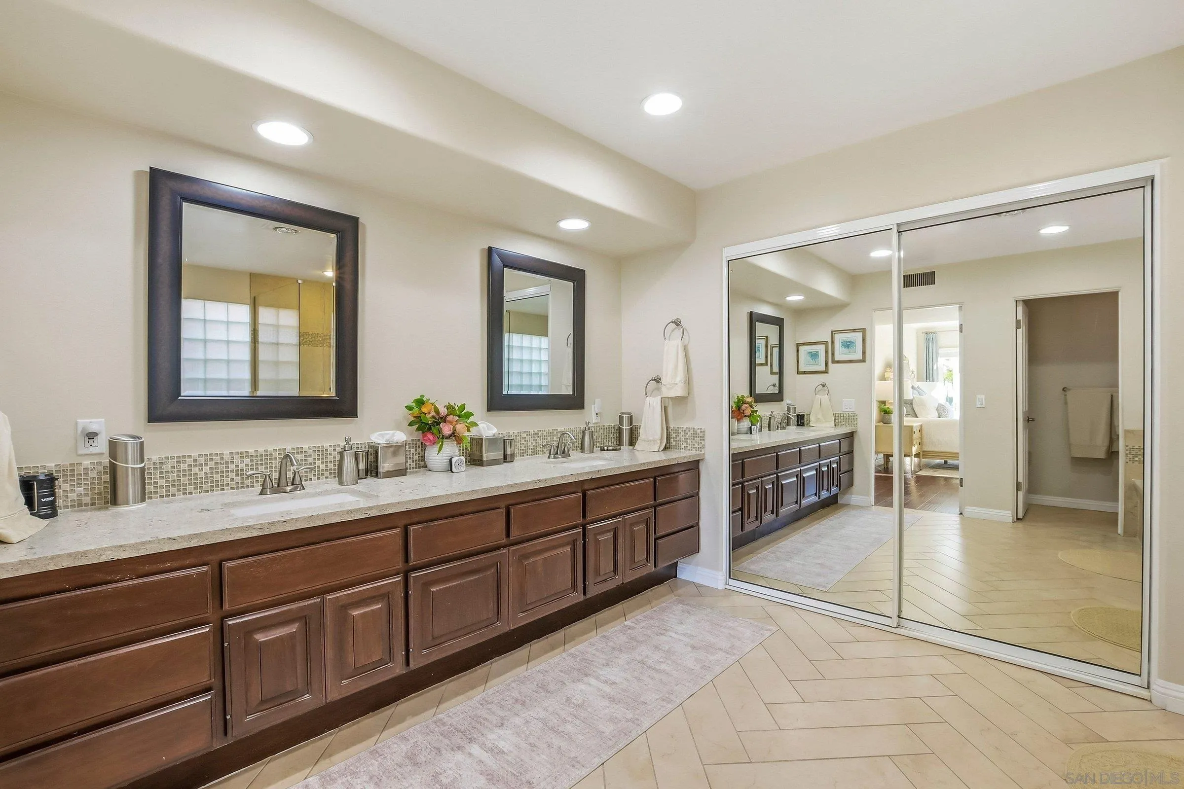 52 Spinnaker Way Coronado, CA 92118 - Photo 20 of 45 a spacious bathroom with a double vanity sink and a mirror
