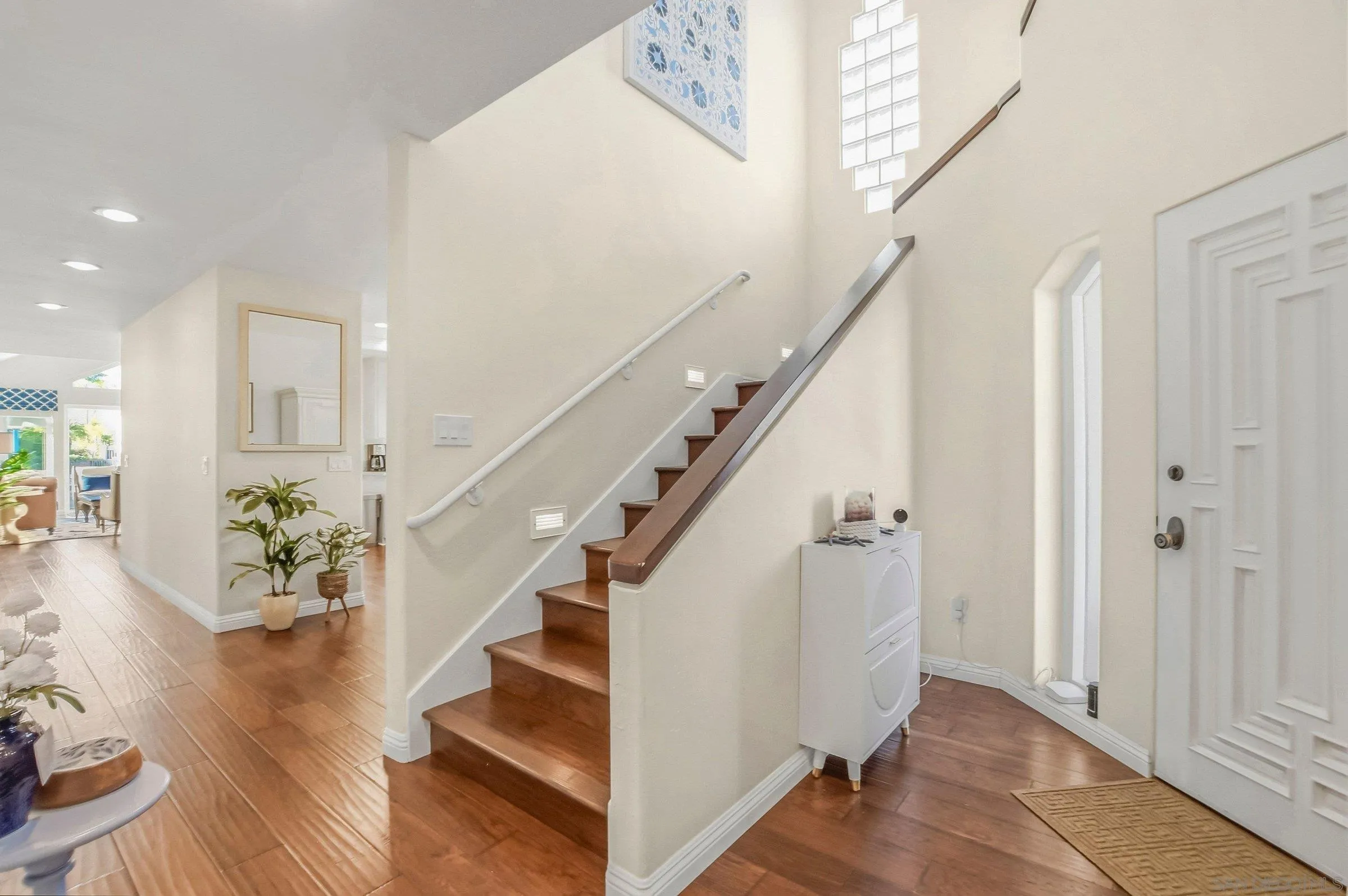 52 Spinnaker Way Coronado, CA 92118 - Photo 4 of 45 a view of entryway with wooden floor and stairs