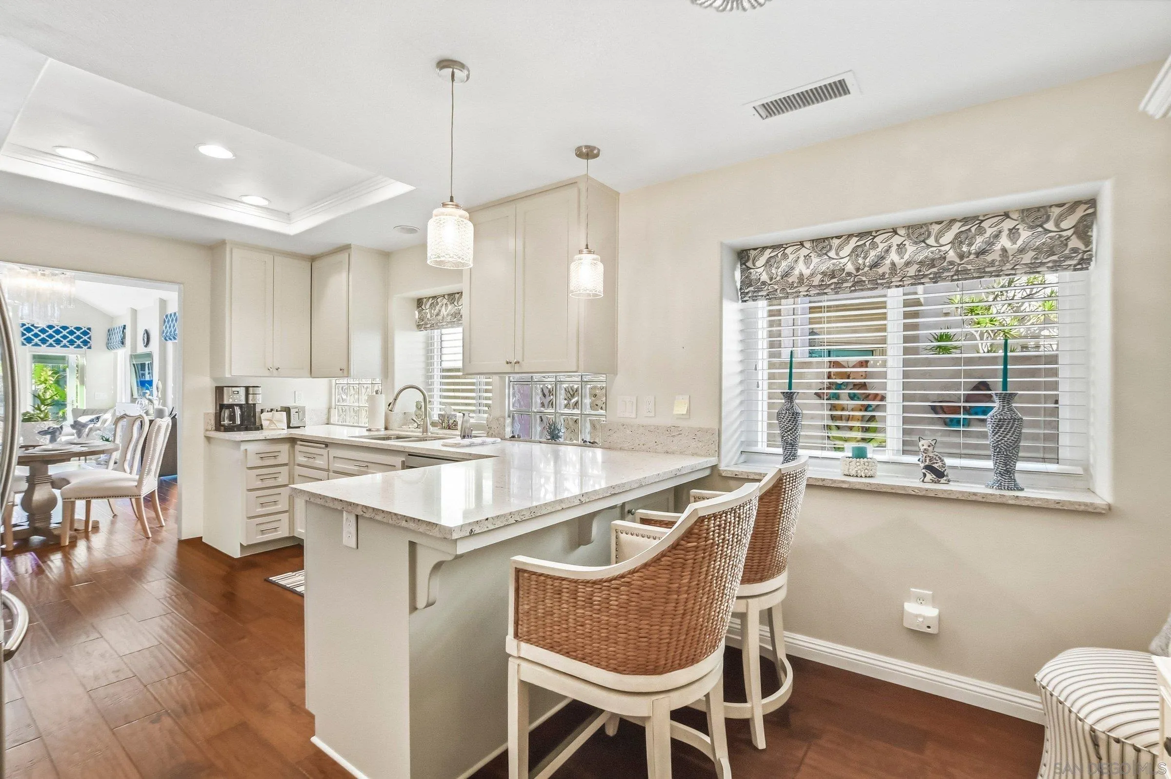 52 Spinnaker Way Coronado, CA 92118 - Photo 6 of 45 a kitchen with granite countertop a stove a sink a dining table and chairs