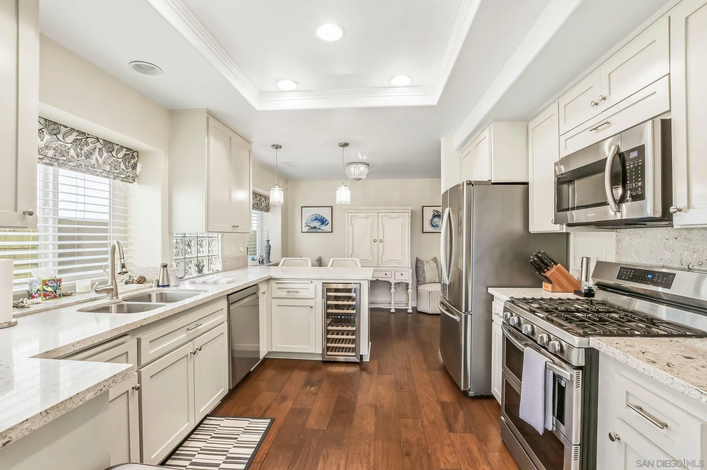 52 Spinnaker Way Coronado, CA 92118 - Photo 7 of 45 a kitchen with white cabinets and stainless steel appliances