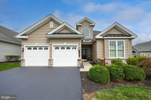 a view of a house with a yard and garage