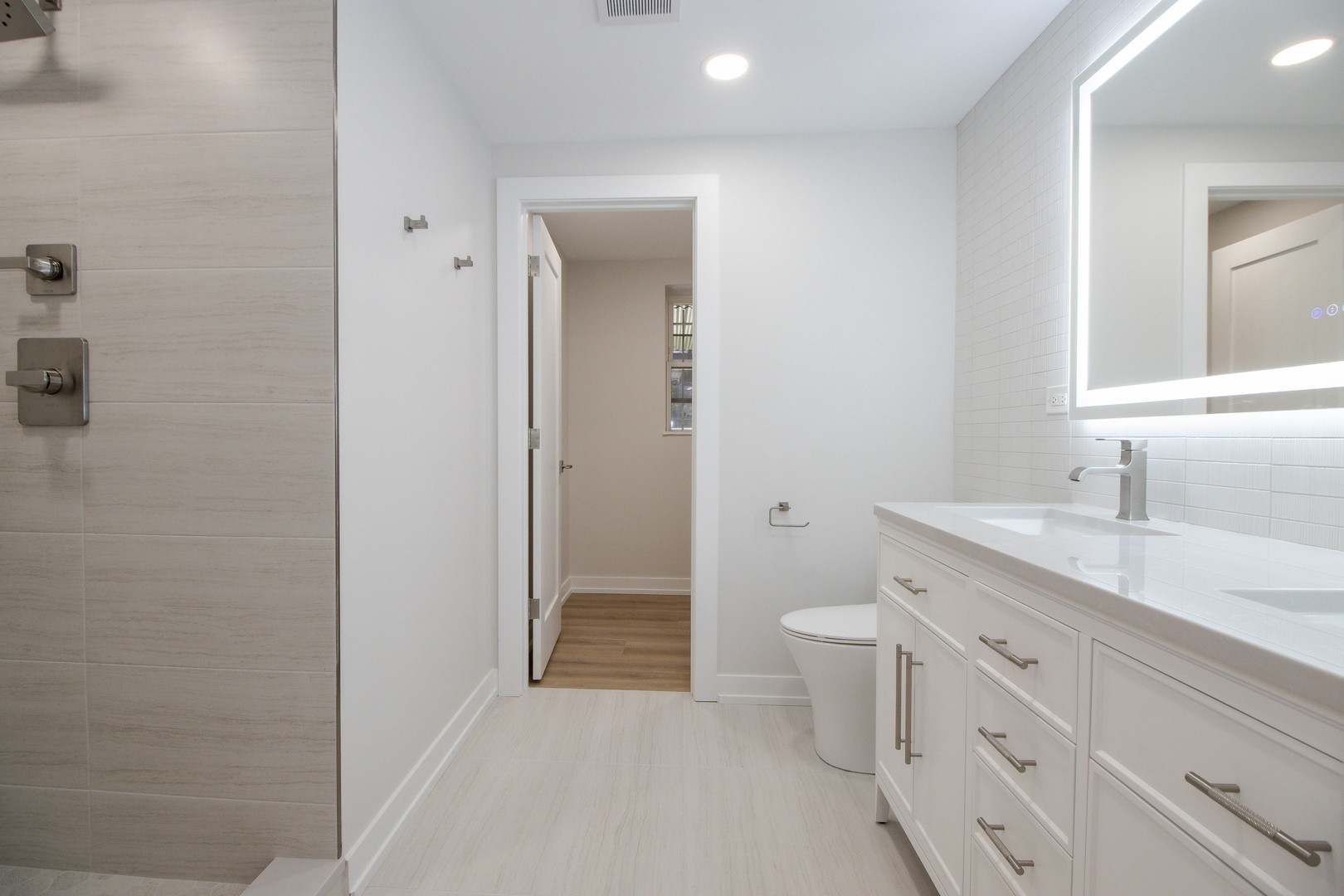 1139 North Winchester Avenue, Unit G Chicago, IL 60622 - Photo 12 of 22 a bathroom with a double vanity sink toilet and shower