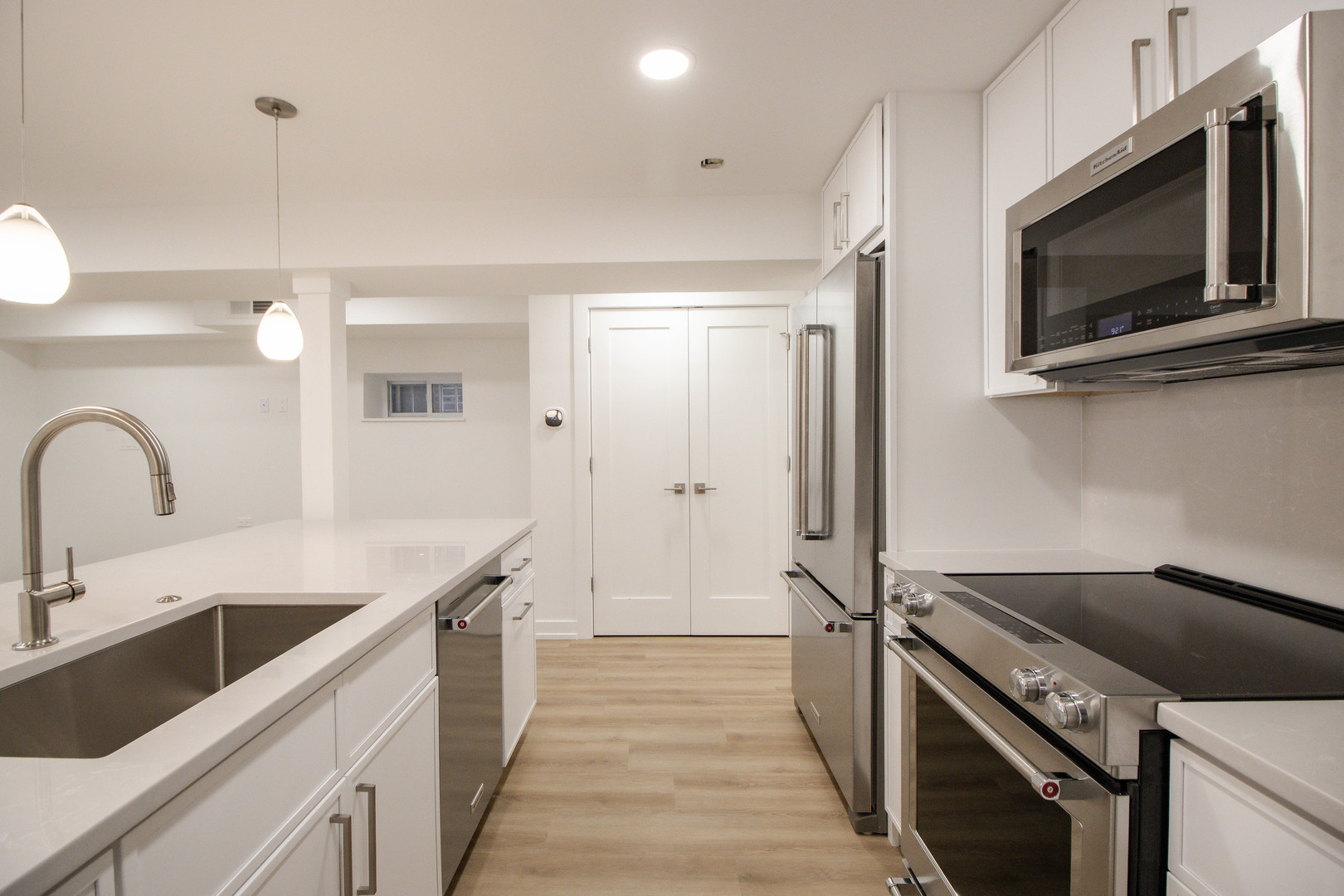 1139 North Winchester Avenue, Unit G Chicago, IL 60622 - Photo 8 of 22 a kitchen with stainless steel appliances granite countertop a sink and a stove
