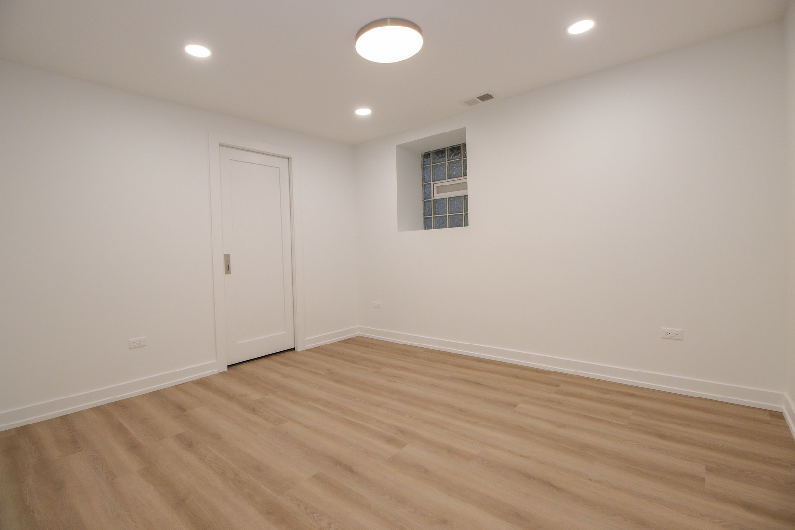 1139 North Winchester Avenue, Unit G Chicago, IL 60622 - Photo 10 of 22 an empty room with wooden floor and windows