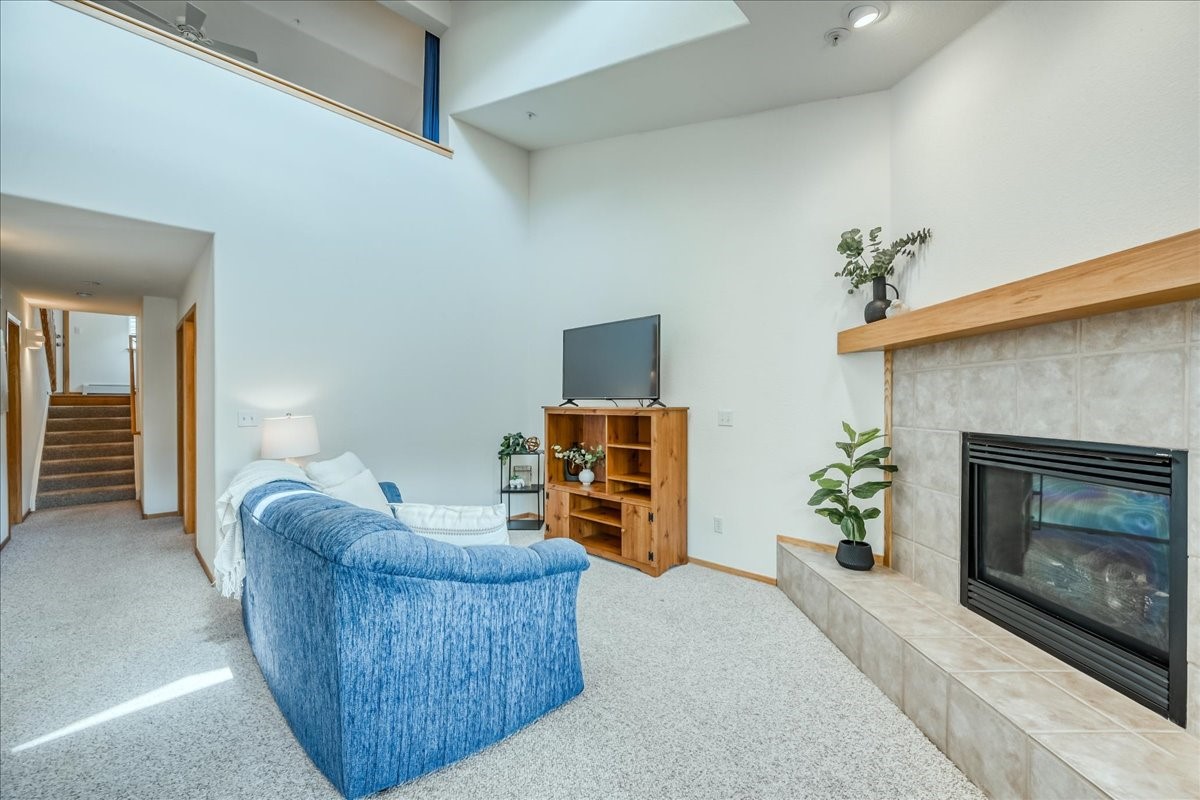 91399 Ryan Gulch Road, Unit B6 Silverthorne, CO 80498 - Photo 5 of 36 a living room with furniture and a fireplace