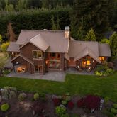 an aerial view of a house with garden space and street view