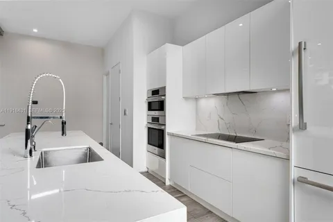a kitchen with a sink and cabinets