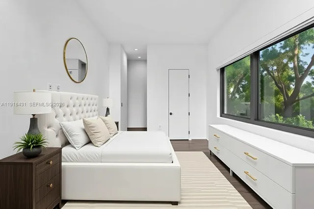 a spacious bedroom with a large bed and a large window