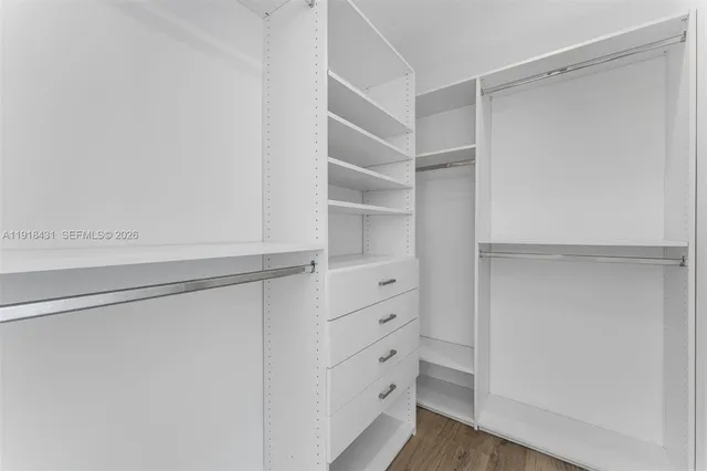 a view of walk in closet with empty racks