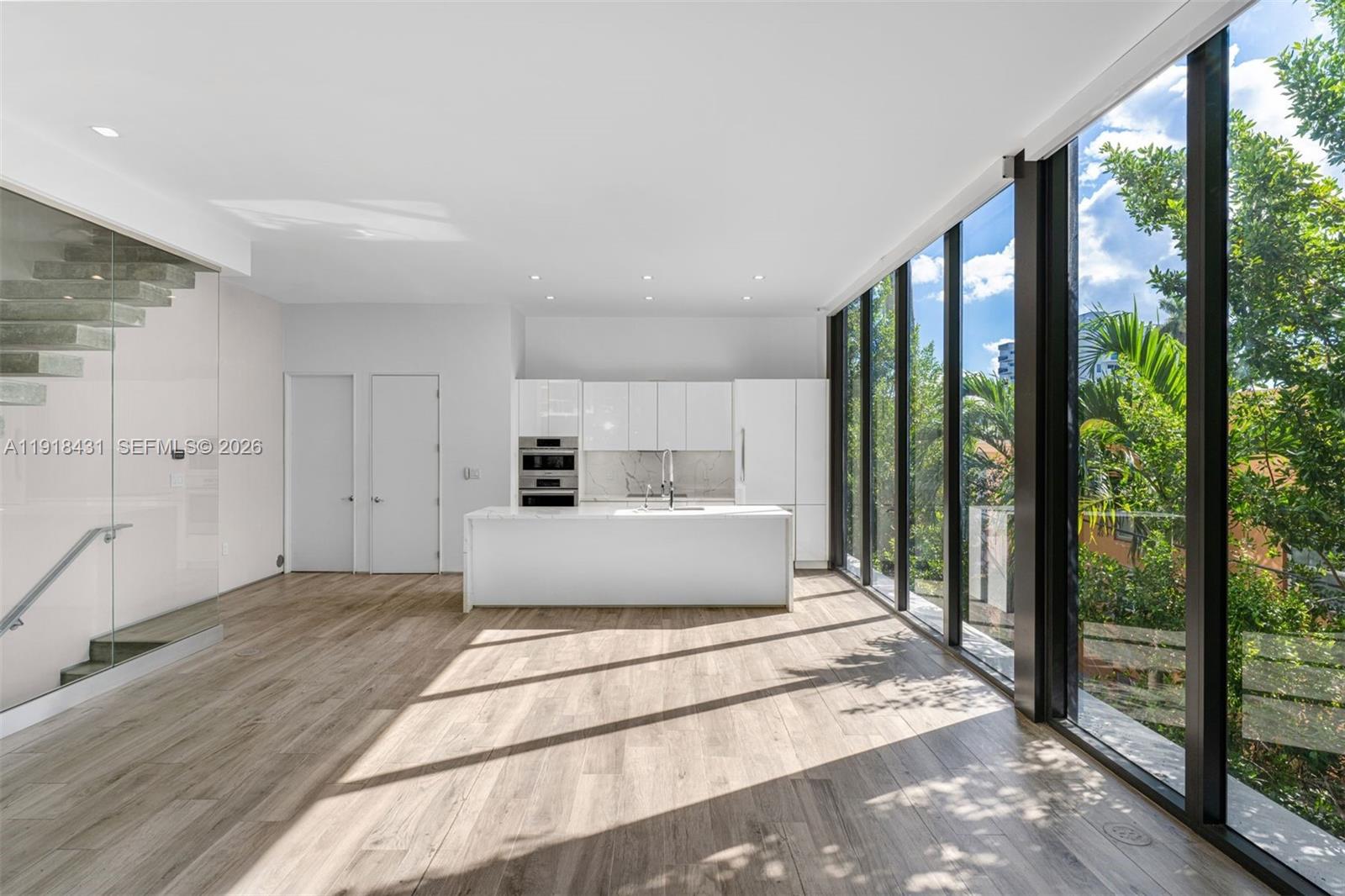 1525 Bay Road, Unit 1525 Miami Beach, FL 33139 - Photo 6 of 37 a view of a big room with a balcony a bed and glass door