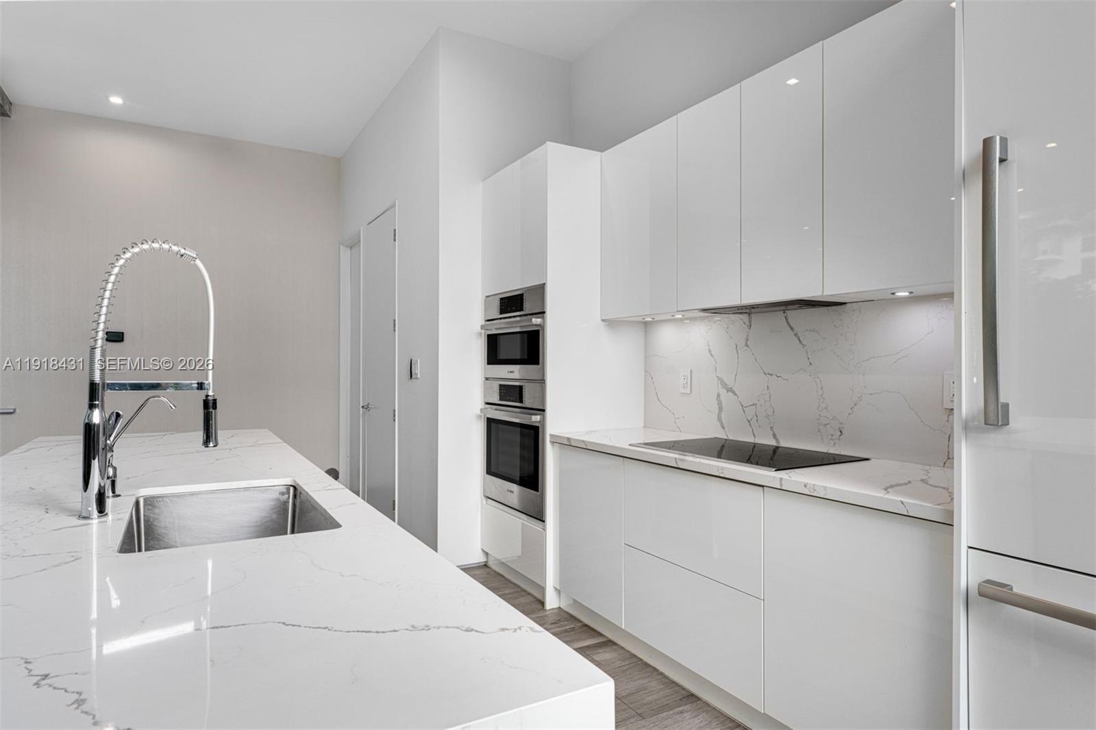 1525 Bay Road, Unit 1525 Miami Beach, FL 33139 - Photo 9 of 37 a kitchen with a sink and cabinets