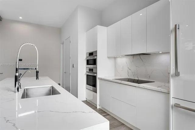 a kitchen with a sink and cabinets